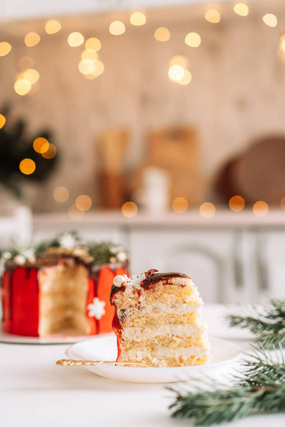 Piece of layer cake against christmas background. - Fotó, kép