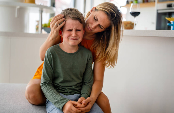 Portrait of mother consoling her crying sad injured son. Child family support pain parent concept - Photo, Image