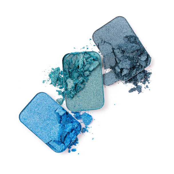 Flat lay of broken blue color eyeshadow as sample of cosmetic beauty product isolated on white background - Foto, Imagen