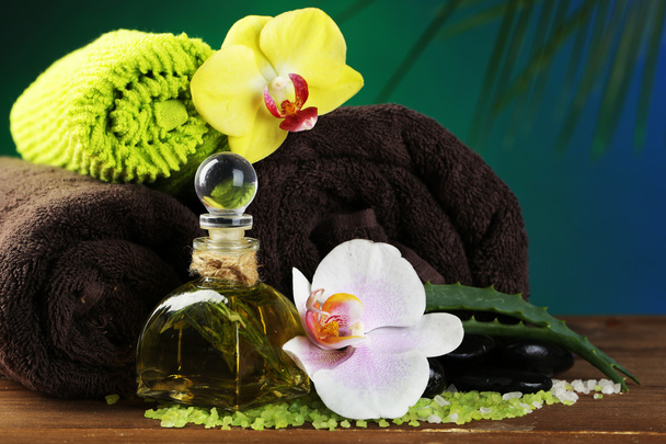 Spa treatments with orchid flowers on wooden table on colorful background - Foto, immagini
