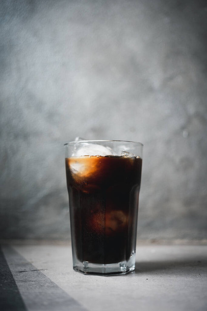Delicious black iced coffee in tall glass, close up - Foto, Imagen