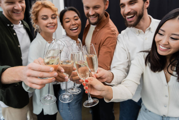 Blurred multicultural business people toasting with champagne in office  - Photo, Image