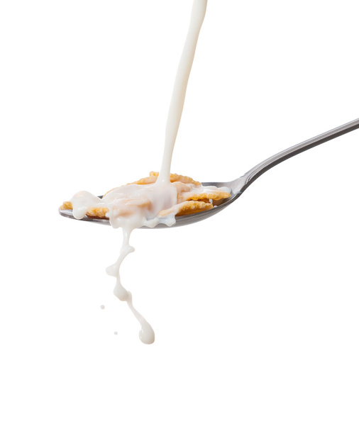 Milk splash on the spoon with cornflakes - Foto, Imagen