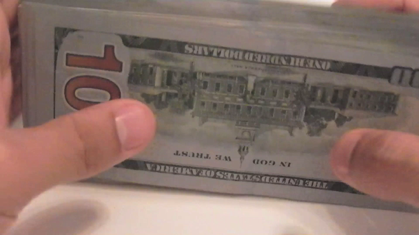 Close-up of a businessman's hands counting hundred dollar bills - Video, Çekim