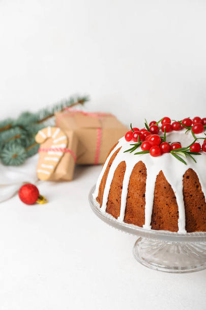 Dessert stand with traditional Christmas cake on light background - Φωτογραφία, εικόνα