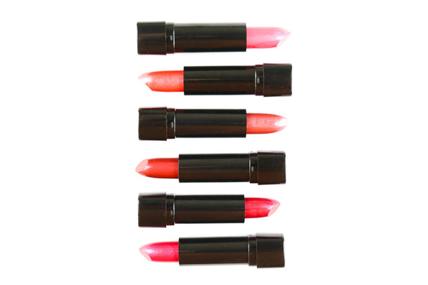 Close up shot of a row of different glossy lipsticks isolated on white background with a lot of copy space for text. - Fotó, kép