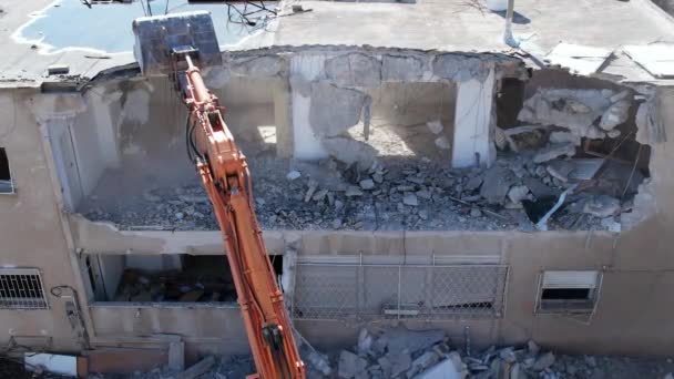 Dismantling of a house. Excavator demolishing barracks for a new construction project.  - Footage, Video