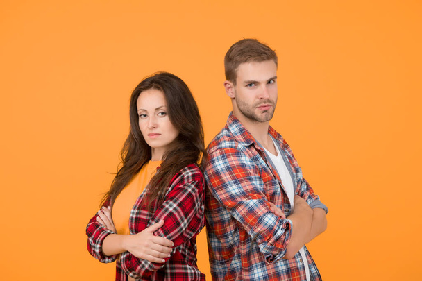 Family look. People concept. Family relations. Adult siblings. Sister and brother. Confident team. Back to back standing man and woman. Fashion clothes shop. Modern couple. Couple checkered shirts. - Valokuva, kuva
