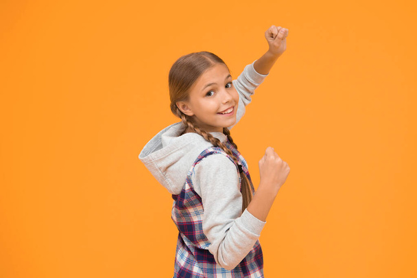 Casual style. Happy international childrens day. Little girl yellow background. Good mood concept. Positive vibes. Sincere emotions. Cute braided girl. Kid long hair. Small girl checkered shirt. - Foto, Bild