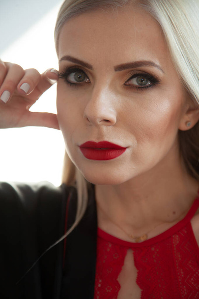 Close up portrait of a beautiful blonde woman with full make up and red lips - Photo, Image