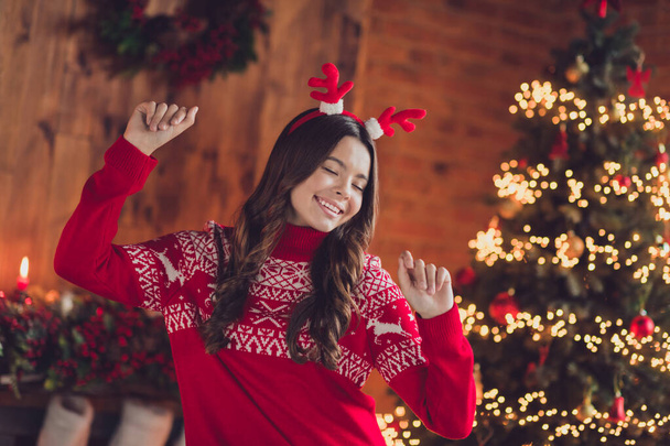 Photo of positive satisfied good mood nice girl with brunette hair wear red ornament jumper dancing have fun clench fists in house indoors. - 写真・画像