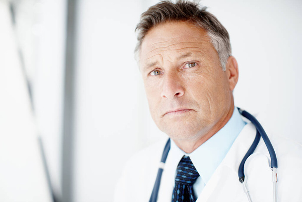He takes the welfare of his patient seriously. A senior surgeon looking at you alongside copyspace - Photo, Image