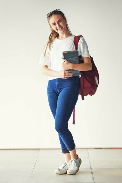 Portrait, education and happy student, textbook and bag ready for college, school or university on campus. Young woman, scholarship and smile for study learning and books with vision, goals or target. - Zdjęcie, obraz