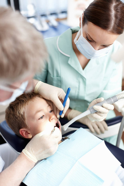 Young dental patient. Portrait of young dental patient taking treatment at dentist clinic - Foto, Imagem