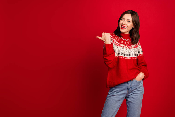 Photo of funky charming lady wear xmas ornament sweater pointing thumb empty space isolated red color background. - Fotografie, Obrázek