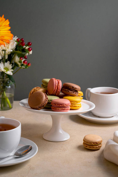 Colorful macaroons, french delicious cookies on cake stand, celebrating, party food - Фото, зображення