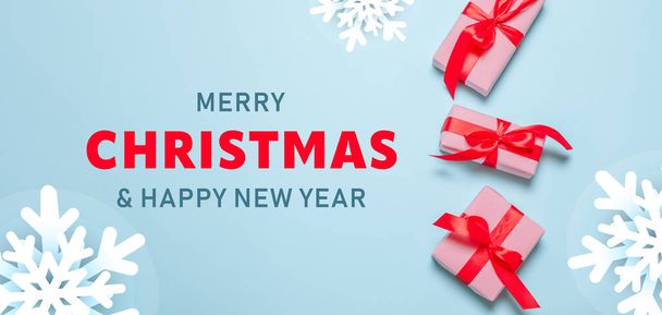 2023 Merry Christmas and Happy Holidays greeting card banner. New Year. Noel. Christmas gifts red ribbons, ornaments on blue background top view. Winter holiday xmas theme. Flat lay.  - Fotografie, Obrázek