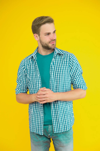 Clothes for daily life. Handsome man unshaven face and stylish hair. Caucasian man yellow background. Bearded man in modern casual style. Handsome guy portrait. Facial hair and skin care concept. - Photo, Image
