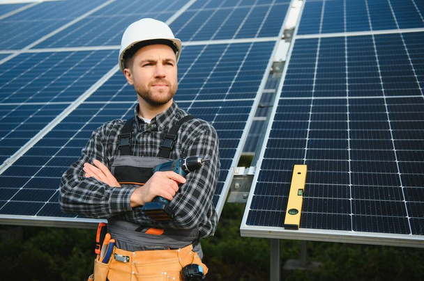 Solar power plant worker checks the condition of the panels. - Photo, Image