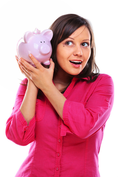 Woman holding pig money-box - Valokuva, kuva