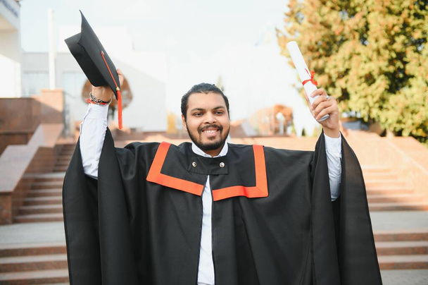 portrait of successful indian student in graduation gown - Foto, afbeelding
