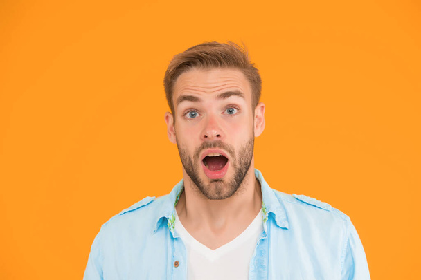 surprised guy with unshaven face. expressing human emotions. bearded sexy man wearing casual shirt. male spring fashion style. mens facial care and beauty. having trendy haircut. - 写真・画像