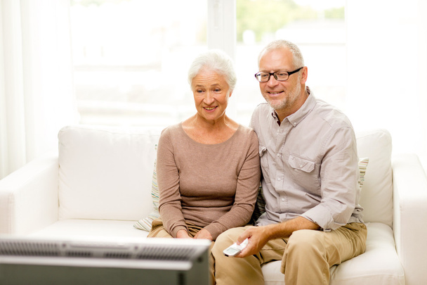 happy senior couple watching tv at home - Photo, Image