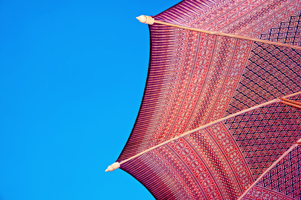 Thailand pattern silk umbrella and sky blue art artist handicraft beach. - Foto, imagen