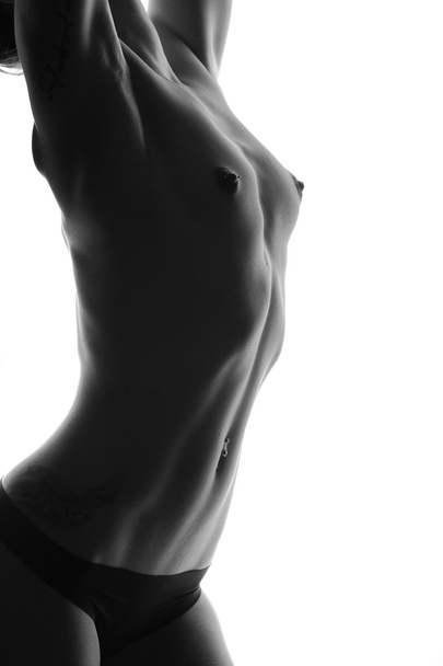 Beautiful body of young woman over dark background  - Zdjęcie, obraz
