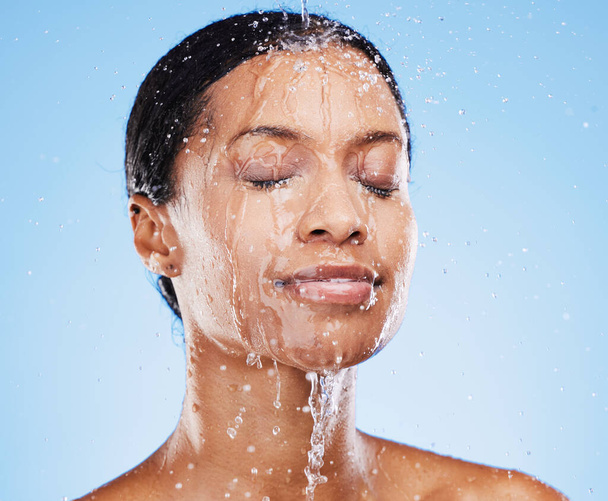 Beauty, skincare and shower with black woman and water splash for cleaning, hydration and natural cosmetics. Moisture, fresh and relax with face of girl model for product, self care and luxury. - Photo, Image