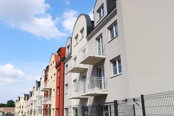 Beautiful view of modern houses with balconies against blue sky - Zdjęcie, obraz