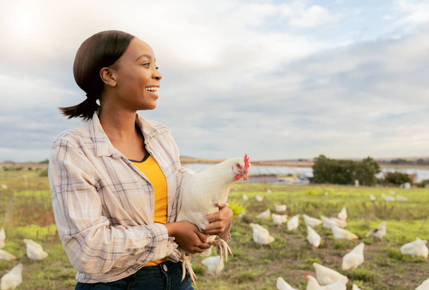 Black woman, chicken farm and happy with small business, growth and agriculture development outdoor in nature. Farmer, animal and sustainability farming with smile and working on countryside poultry. - Photo, image
