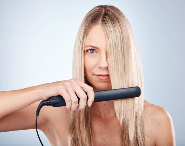 Hair care, portrait and face of woman with hair straightener for luxury styling, hairstyle maintenance or hairdressing. Spa salon, cosmetics studio product and model with hair iron for hair treatment. - Fotografie, Obrázek