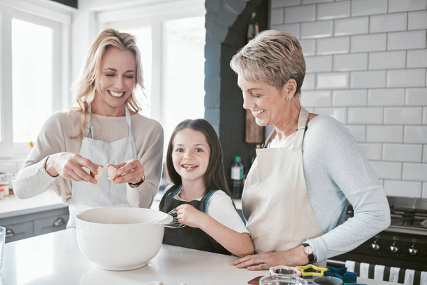 .Family, learning and cooking with grandmother in kitchen together for bond, cookies and wellness. Food, baking and mother teaching young daughter baker recipe with grandma in Australia home - Photo, Image