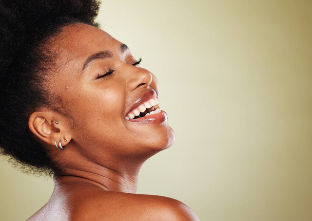 Schönheit, Hautpflege und schwarze Frau mit einem Lächeln in einem Studio mit einem natürlichen Gesicht Routine mit Attrappe Raum. Glückliches, kosmetisches und afrikanisches Modell mit einer Gesichtsbehandlung vor grünem Hintergrund - Foto, Bild