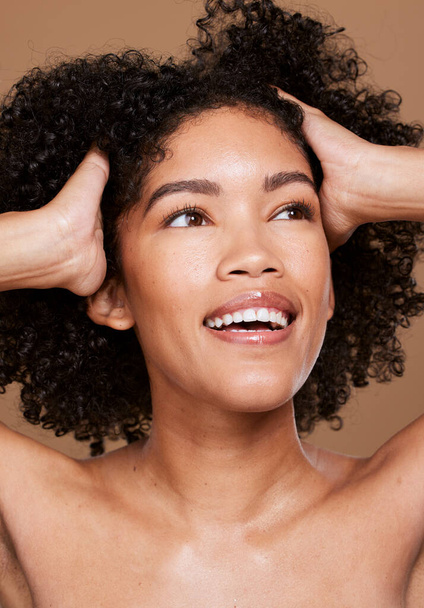 Black woman, beauty and face skincare, wellness and hair care with makeup, glow or cosmetics on brown studio background. Happy female model, facials cosmetic and happy smile for healthy or clean skin. - Photo, image