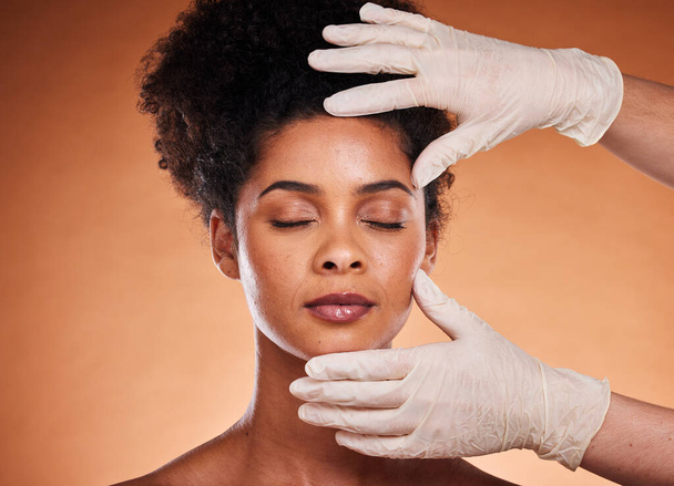 Plastic surgery, cosmetics and black woman in studio with medical hands for botox, aesthetic or facial dermatology help, support and trust. Mesotherapy, hyaluronic acid or collagen of girl model face. - Φωτογραφία, εικόνα