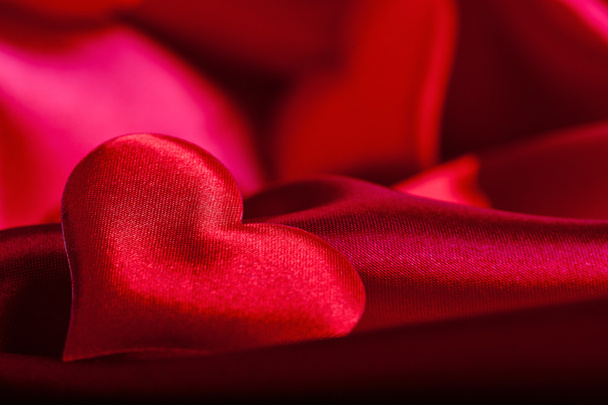 Red heart Valentine's Day symbols on red silk background close up - Photo, image
