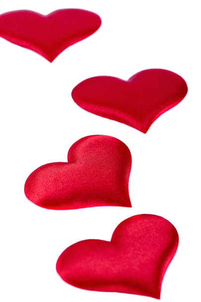 Four red hearts Valentine's Day symbols on a white background closeup - Foto, Bild