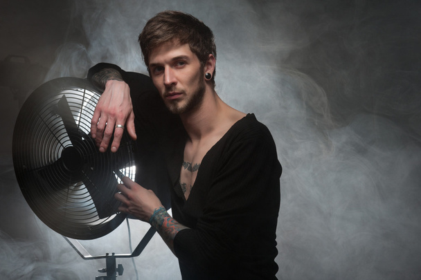 Men with fan on the smoke - Photo, Image