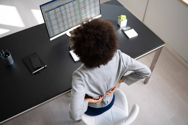 Back Pain Bad Posture Woman Sitting In Office - 写真・画像
