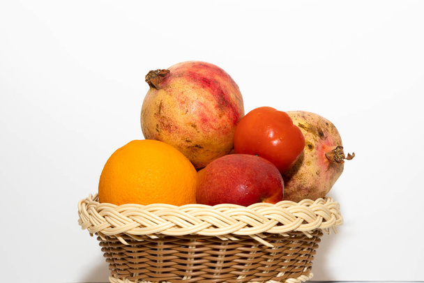 Closeup Image Of Fresh Fruits In Basket In White Background - Foto, Imagem