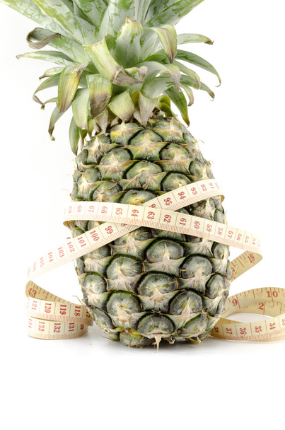 pineapple with measuring tape - Foto, afbeelding