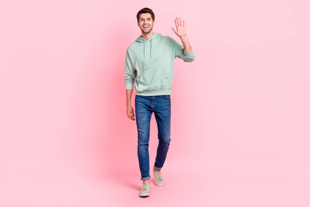 Full length photo of satisfied man dressed grey denim clothes raise arm say hi rejoice meet close friend isolated on pink color background. - Fotoğraf, Görsel