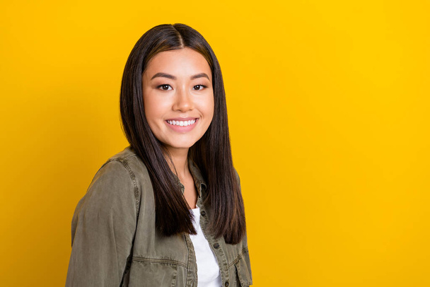 Portrait of nice glad girl with long hairstyle dressed khaki shirt smiling stomatology clinic ad isolated on yellow color background. - Photo, image