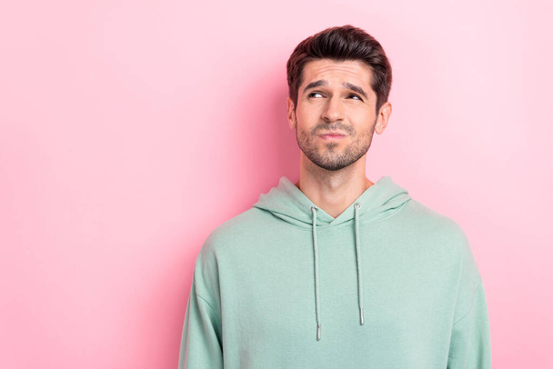 Photo of young uncertain funny guy pouted lips looking empty space advert dont know buy product price high low quality isolated on bright pink color background. - Foto, Imagen