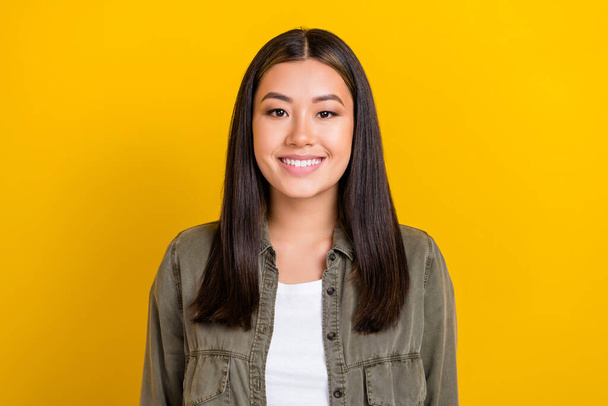 Portrait of pretty nice cute satisfied girl with long hairstyle wear khaki shirt smiling at camera isolated on yellow color background. - Valokuva, kuva
