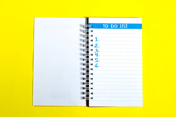 To do Liste der Dinge oder Aufgaben für das Leben zu vervollständigen, Geschäftsprojekt Plan Konzept, Notizblock mit Überschrift To do Liste und Liste der Zahlen auf gelbem Hintergrund - Foto, Bild