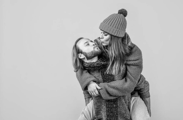 kiss me sweetie. christmas fun. knitted fashion. man and woman in sweater hat and scarf. happy family wear warm clothes. couple in love spend winter holidays. cold season vacation and activity. - Foto, Bild