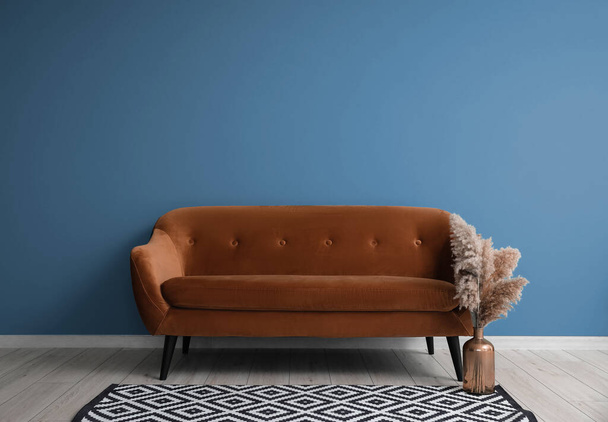 Comfortable sofa near blue wall - Фото, зображення